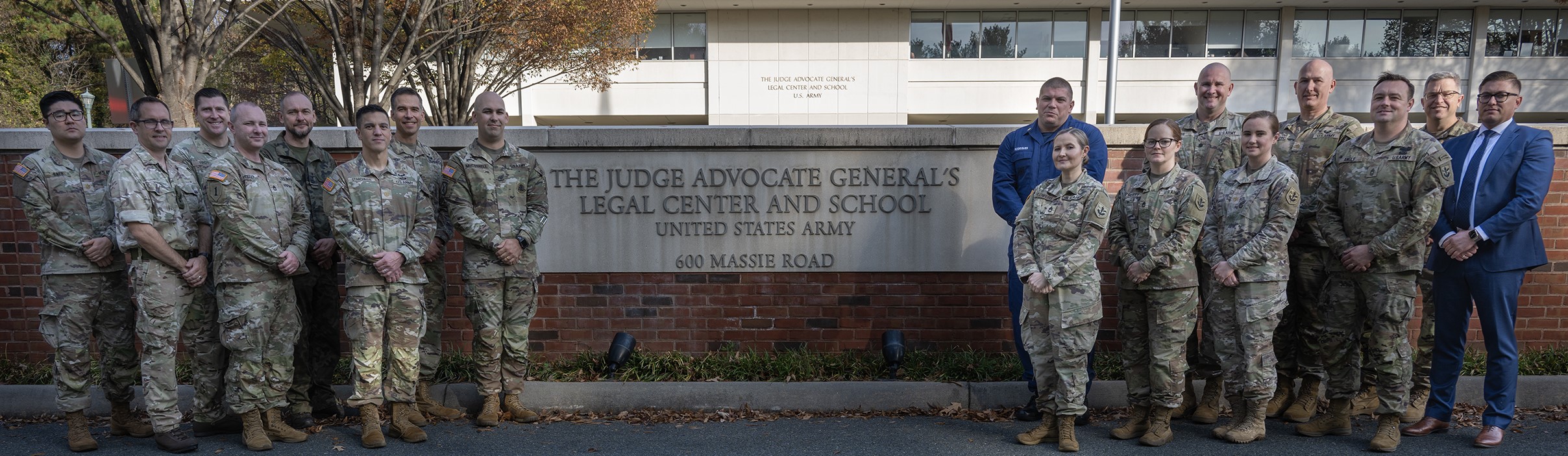 Soldiers posing in front of The Judge Advocate General's Legal Center and School